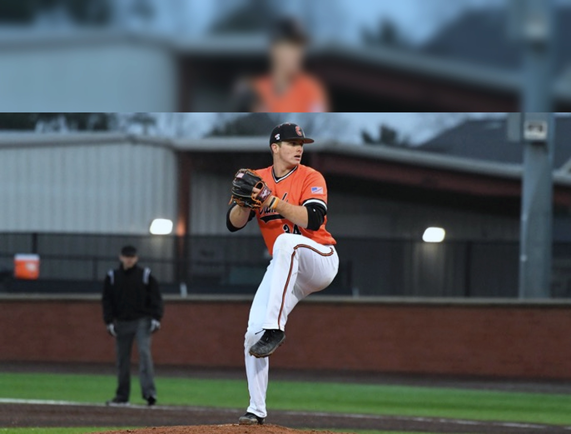 Baseball pitcher in mid-pitch